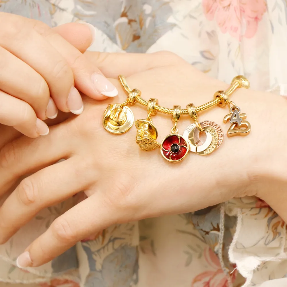 Gold Remember bracelet with charms