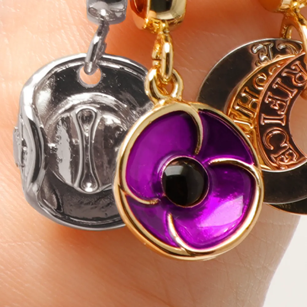 Close up of purple poppy and slouch hat charms